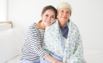 caregiver and senior woman smiling