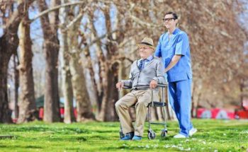 caregiver assisting senior man